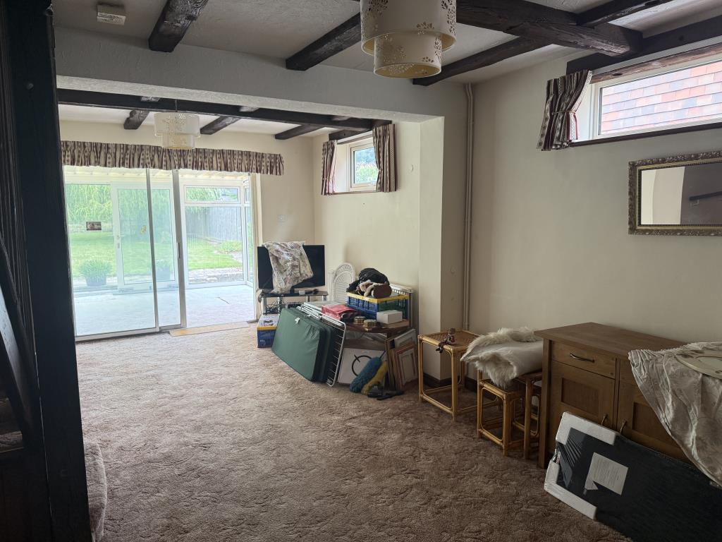 Lot: 109 - FOUR-BEDROOM DETACHED BUNGALOW FOR IMPROVEMENT ON 0.21 ACRES - Living room with view to conservatory